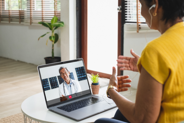 decorative image showing a patient talking to a doctor through a computer